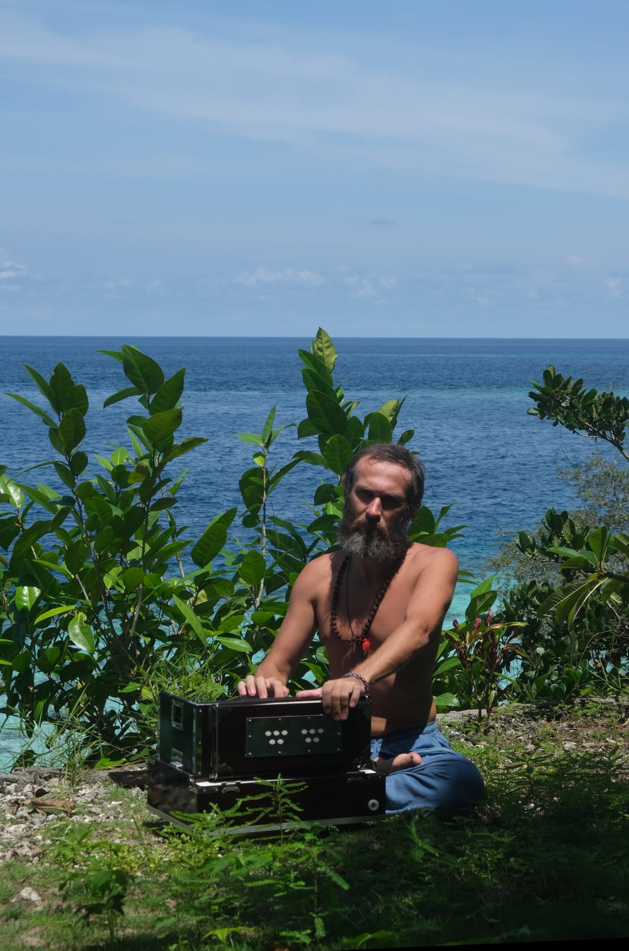 Person practicing drone music meditation for focus and harmony on remote island, Bali, Sulawesi, Indonesia